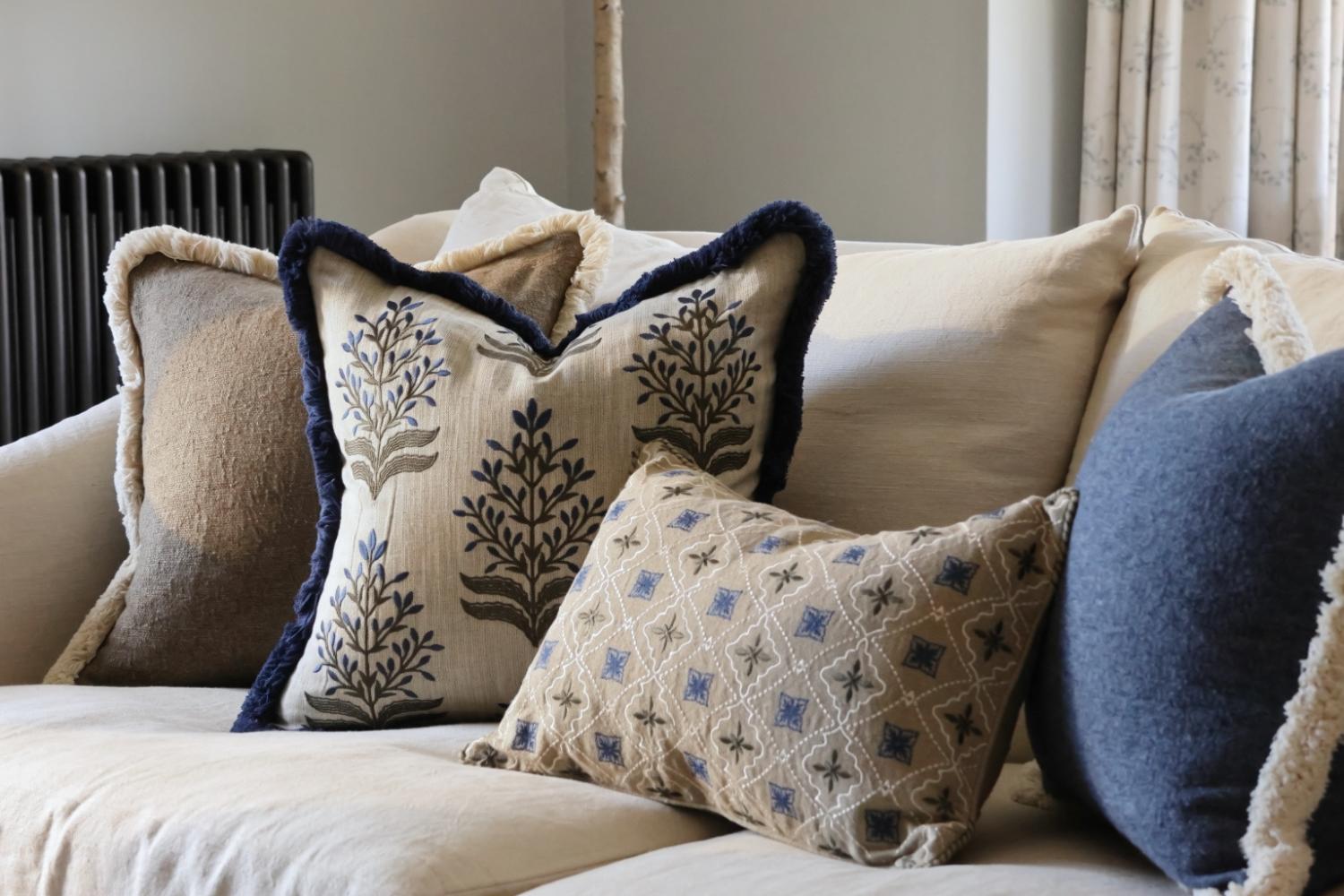 Luxury layered cushion covers styled on a sofa by The Suffolk Nest