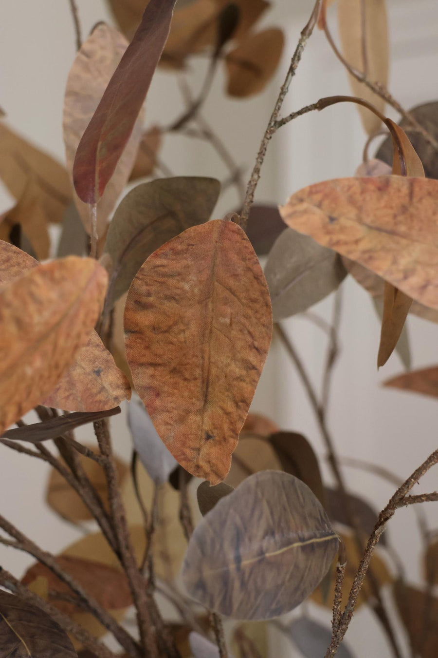 Close-up of artificial autumn leaves with a neutral background