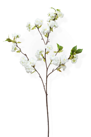Faux white blossom stem with green leaves on white background