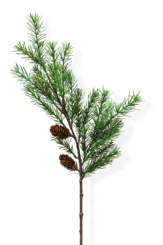 Artificial pine branch with cones on a white background