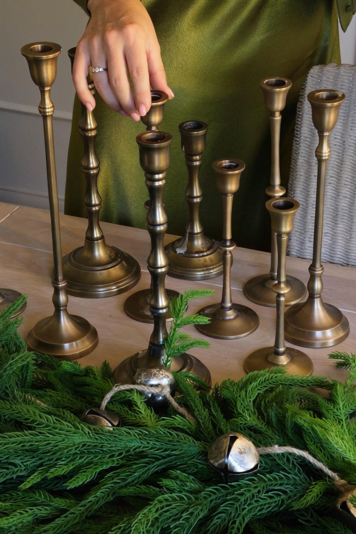 A collection of brass candlesticks on a wooden table