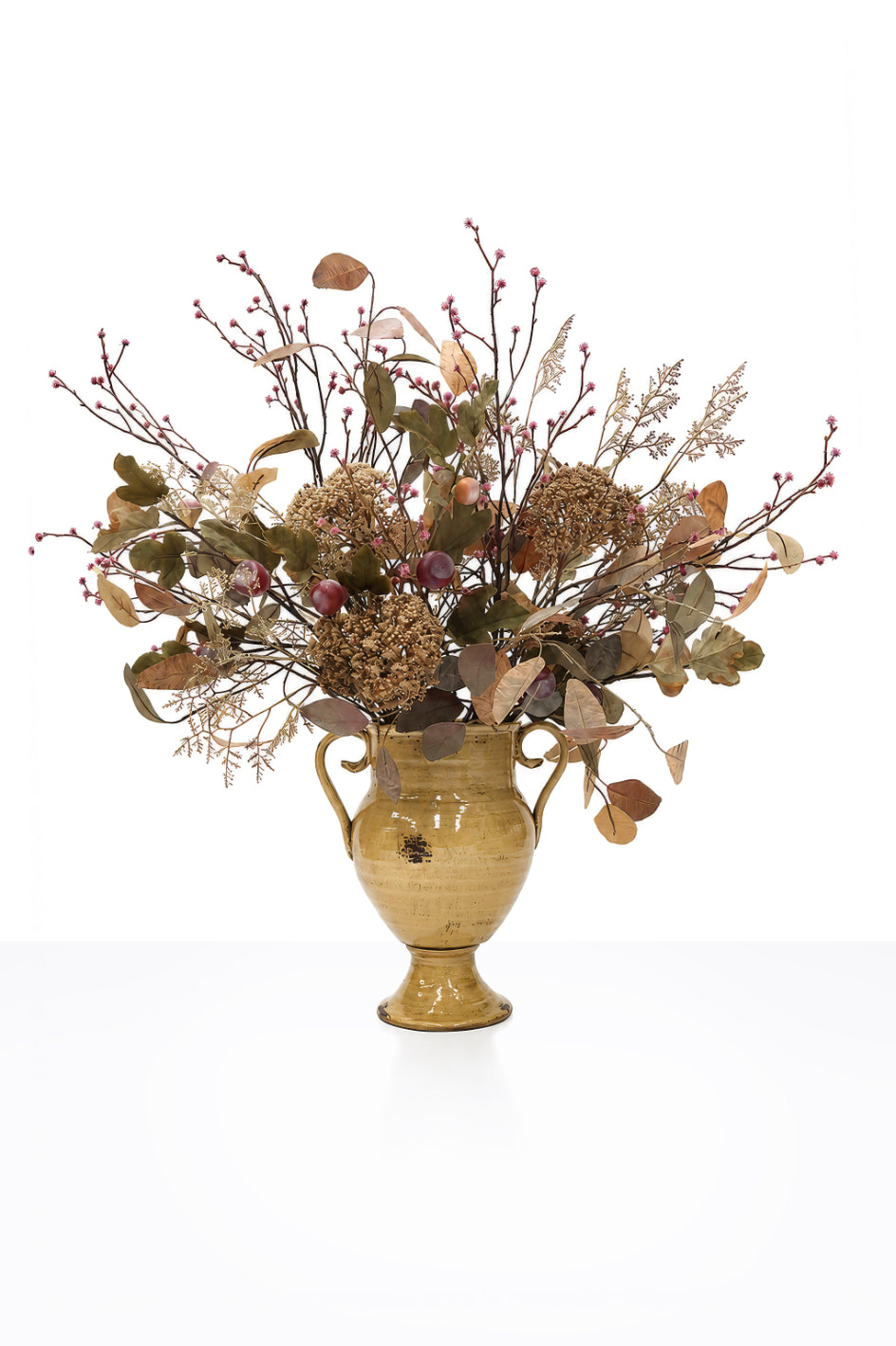 Artificial Autumn Fig Arrangement in a mustard ceramic urn on white background
