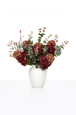 Artificial Autumn Crimson Hydrangea Arrangement in a white ceramic vase on white background