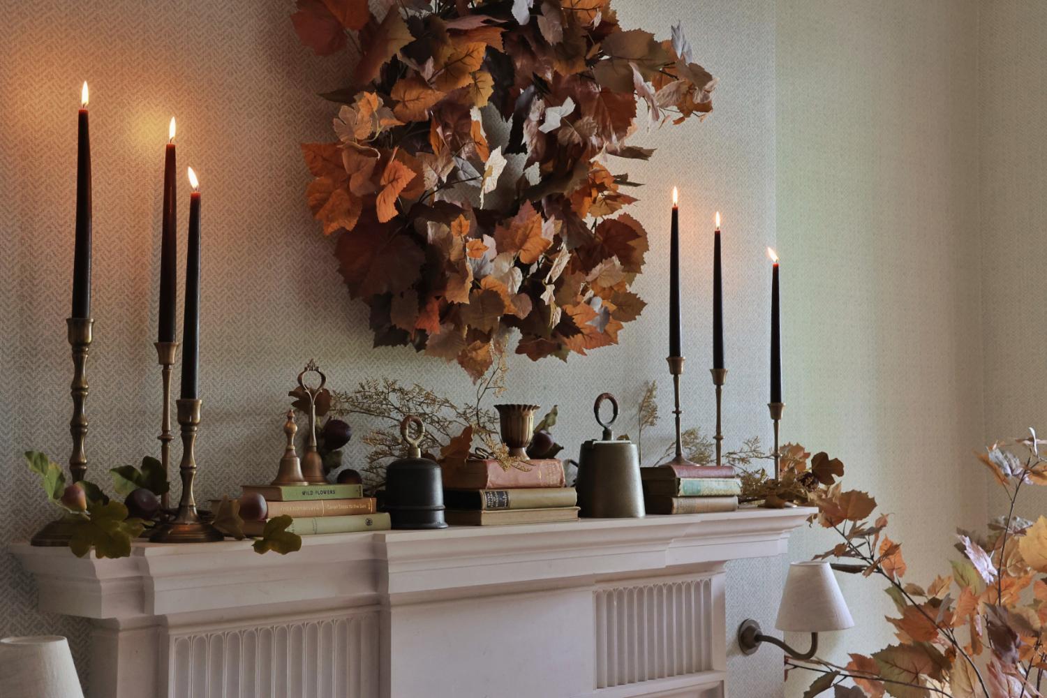 Artificial fallen leaves wreath on a mantle dressed up for autumn.