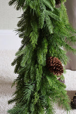 Artificial green garland with a pine cone on a neutral background