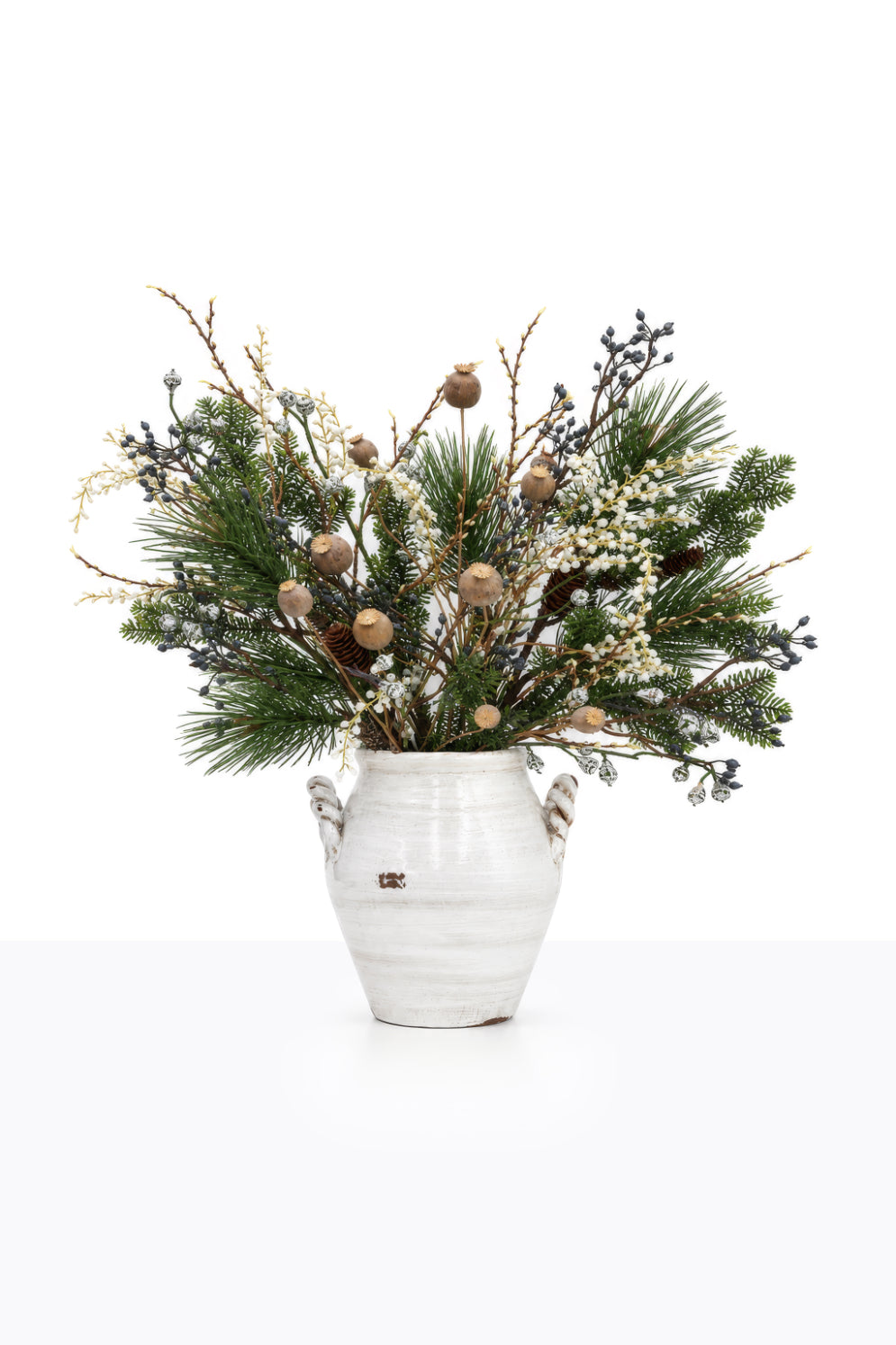 Artificial Christmas Blue Berry Arrangement in a ceramic urn on white background