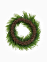 Back of a faux Christmas Pine wreath on white