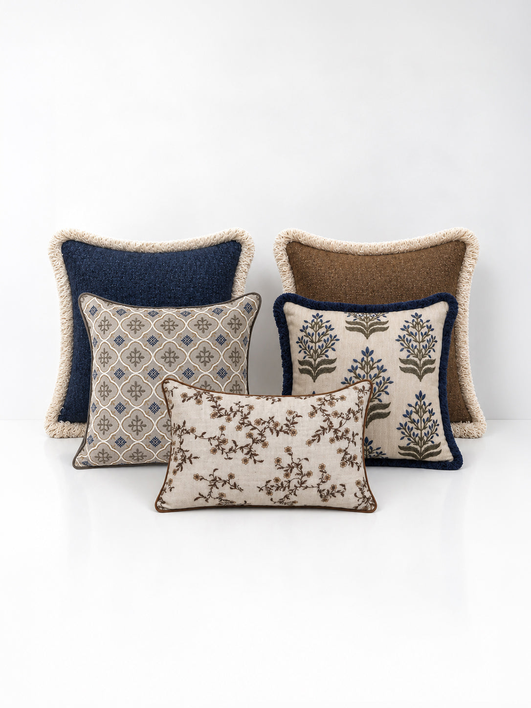 A set of decorative cushions on a white background
