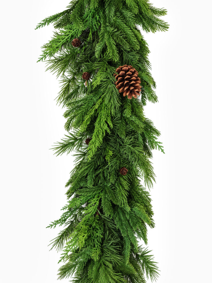 A long artificial christmas foliage garland on white