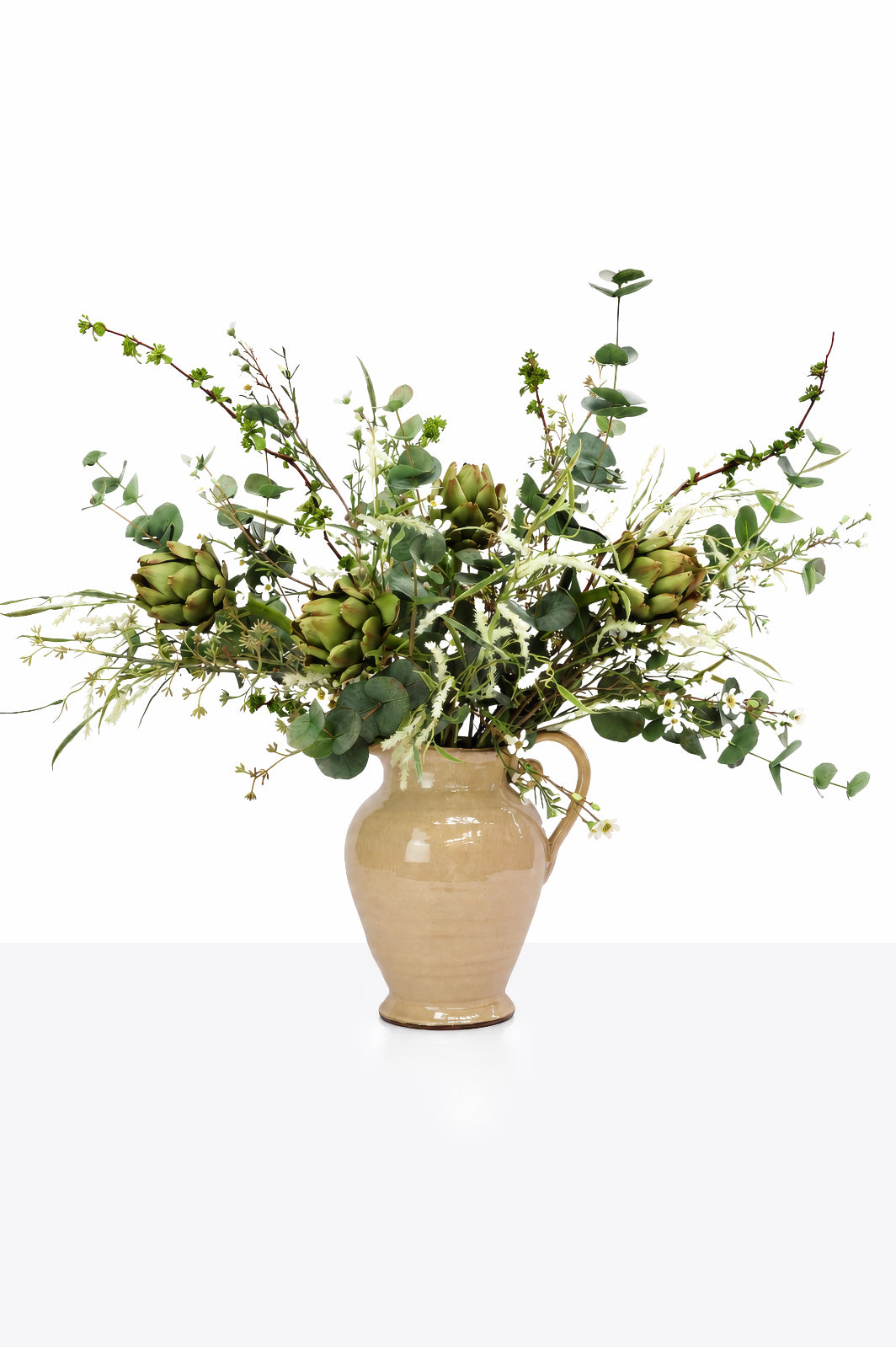 A large Artificial Artichoke Arrangement in a cream jug on a white background