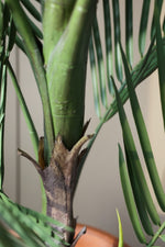 Close-up of a faux palm tree with a blurred background