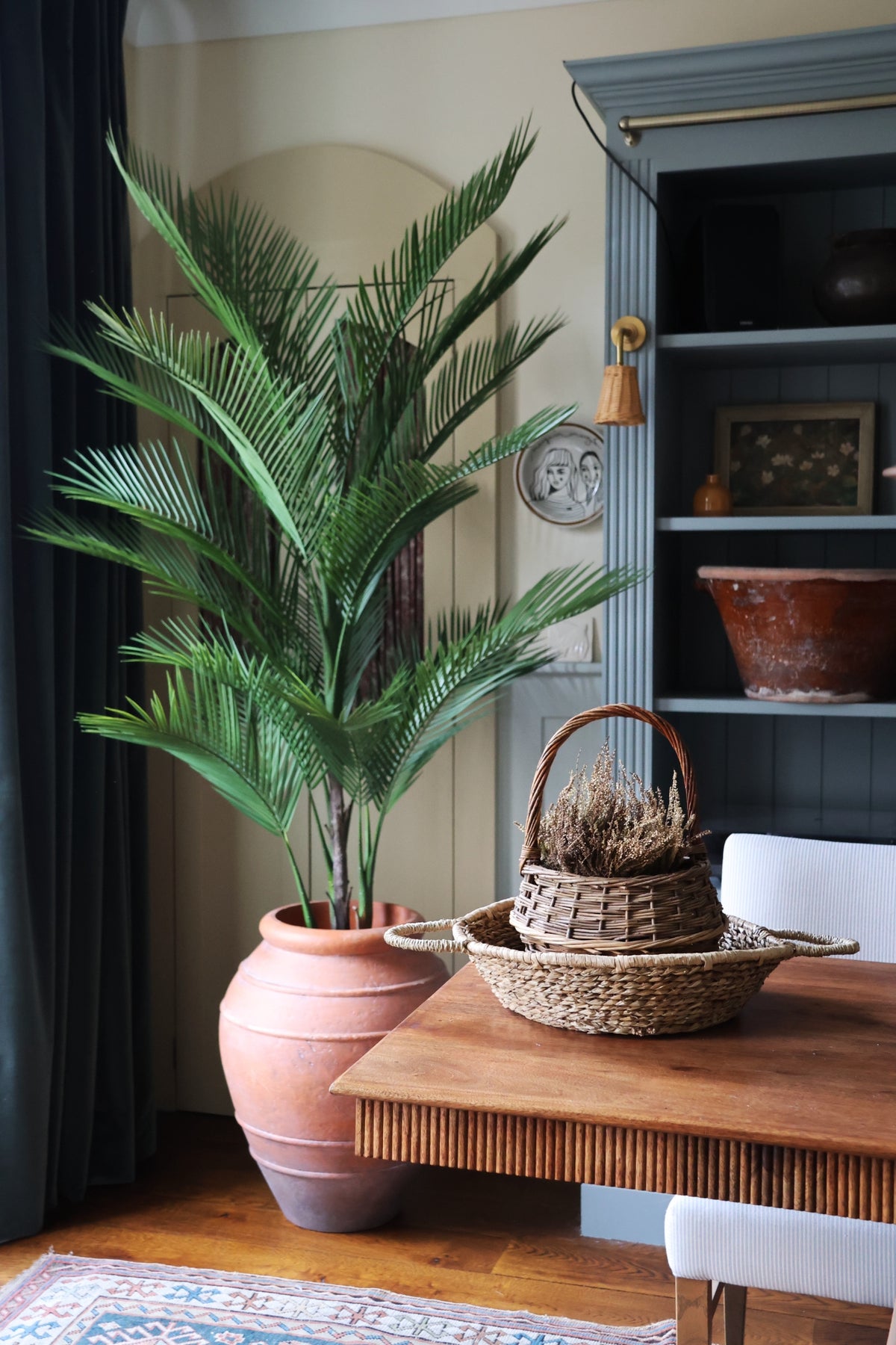 Faux palm tree 180cm in an ultra-lite wickham planter next to a wooden desk 