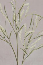 faux wild grass stem with cream seed heads on pale grey background