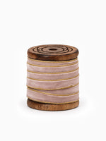 Spool of Gold Edged Velvet Champagne Ribbon on white for Christmas