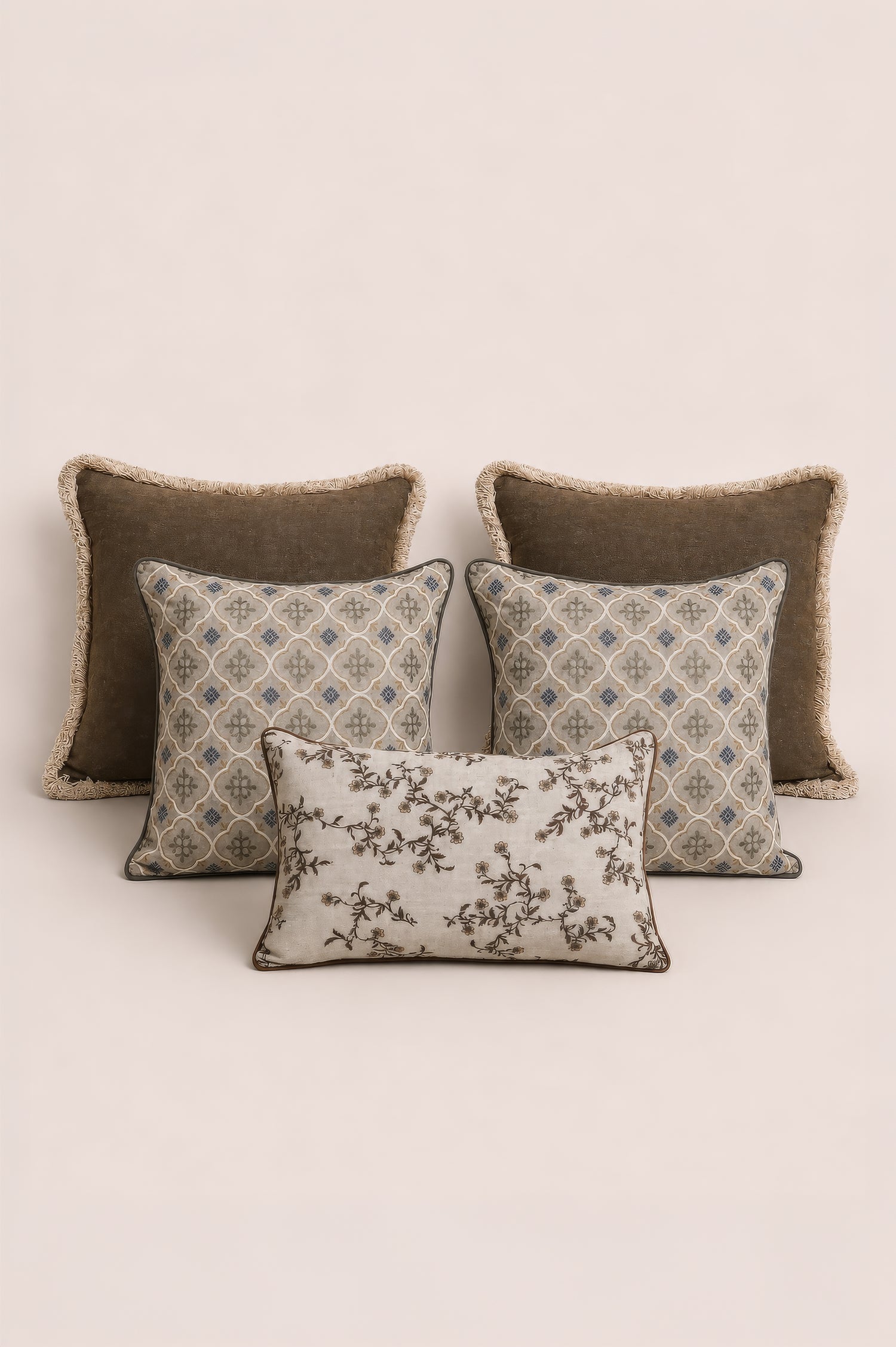 Four decorative cushions with different patterns on a beige background