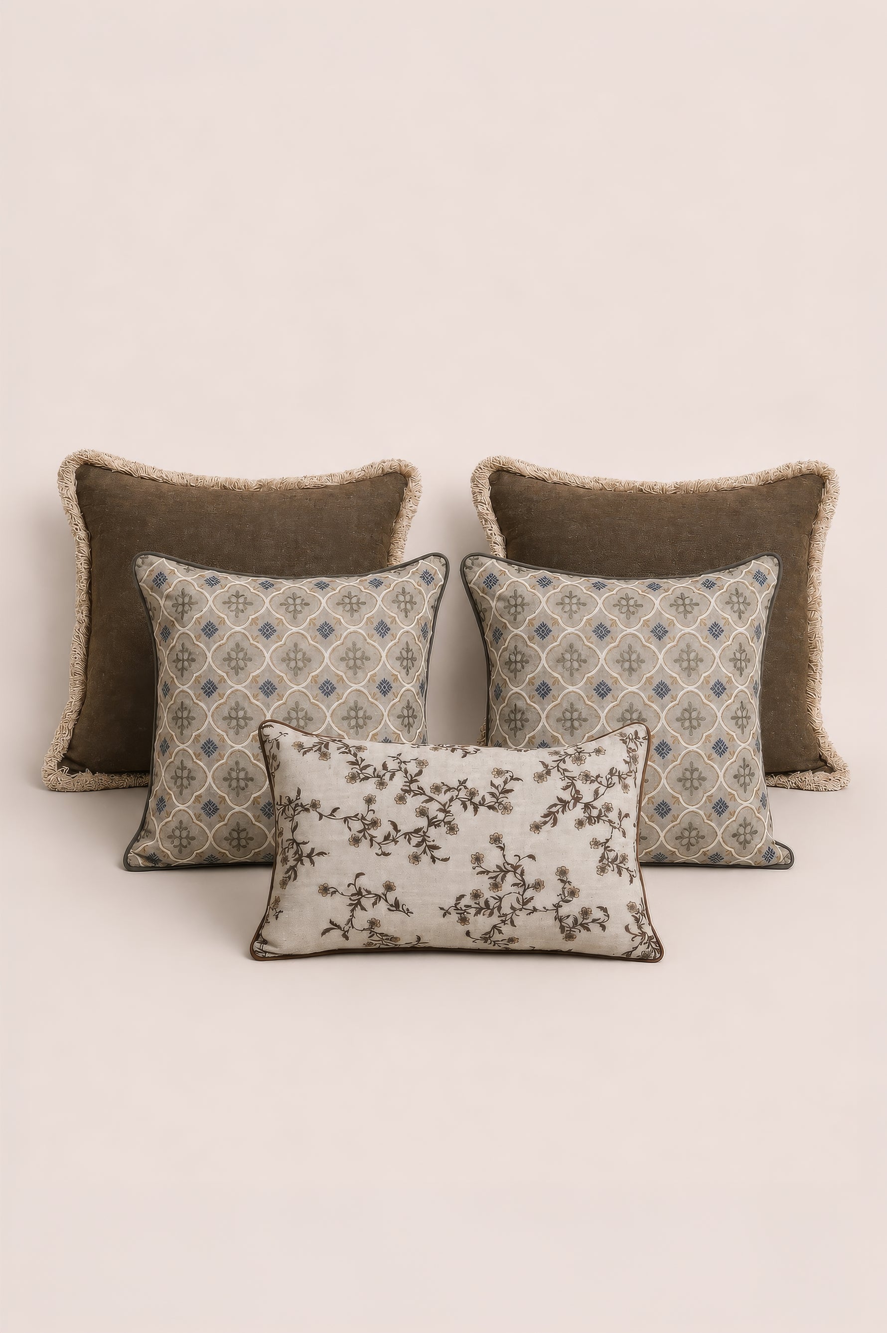 Four decorative cushions with different patterns on a beige background