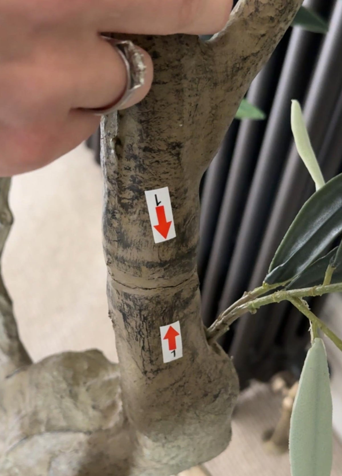 Faux Olive tree being slotted together following the numbered arrows on the trunk