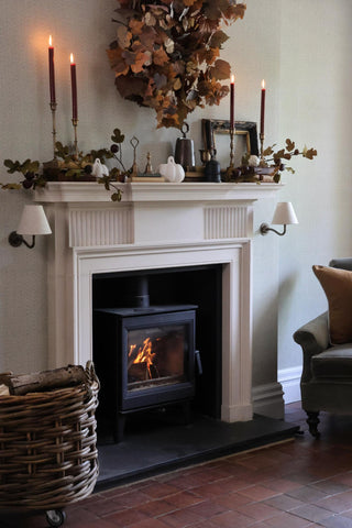 Cozy living room with a fireplace, candles, and decorative items.
