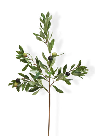Artificial olive branch with green leaves and small black fruits on a white background