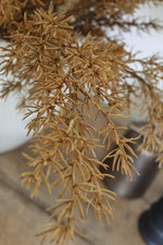 artificial autumn branches against a blurred background