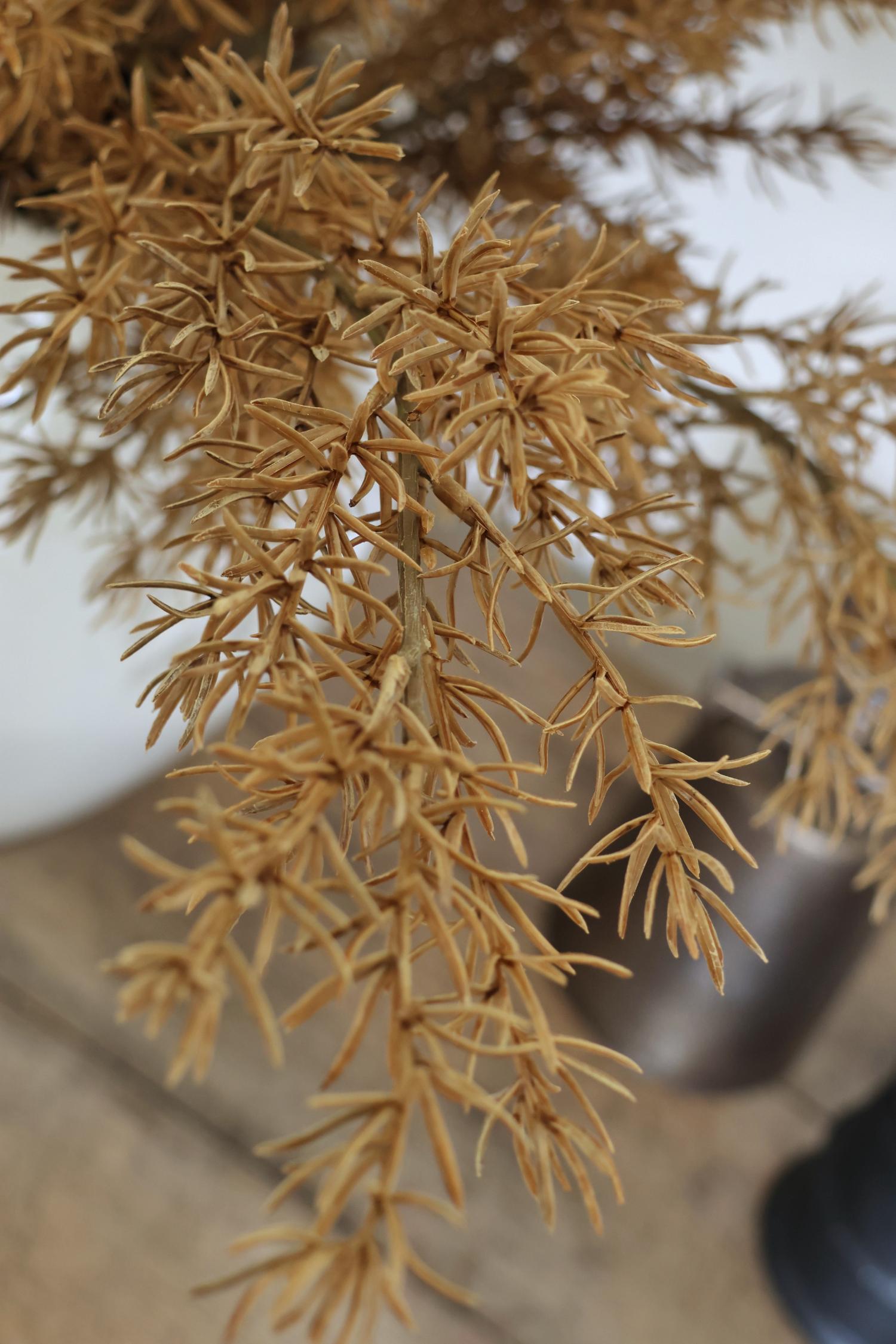 artificial autumn branches against a blurred background