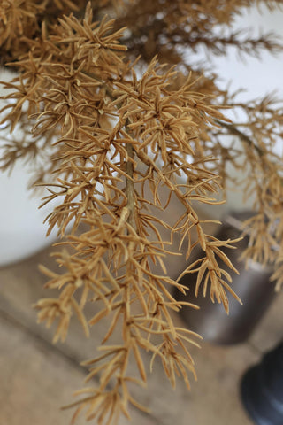 artificial autumn branches against a blurred background