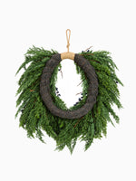 Back of a faux Juniper Berry wreath on white