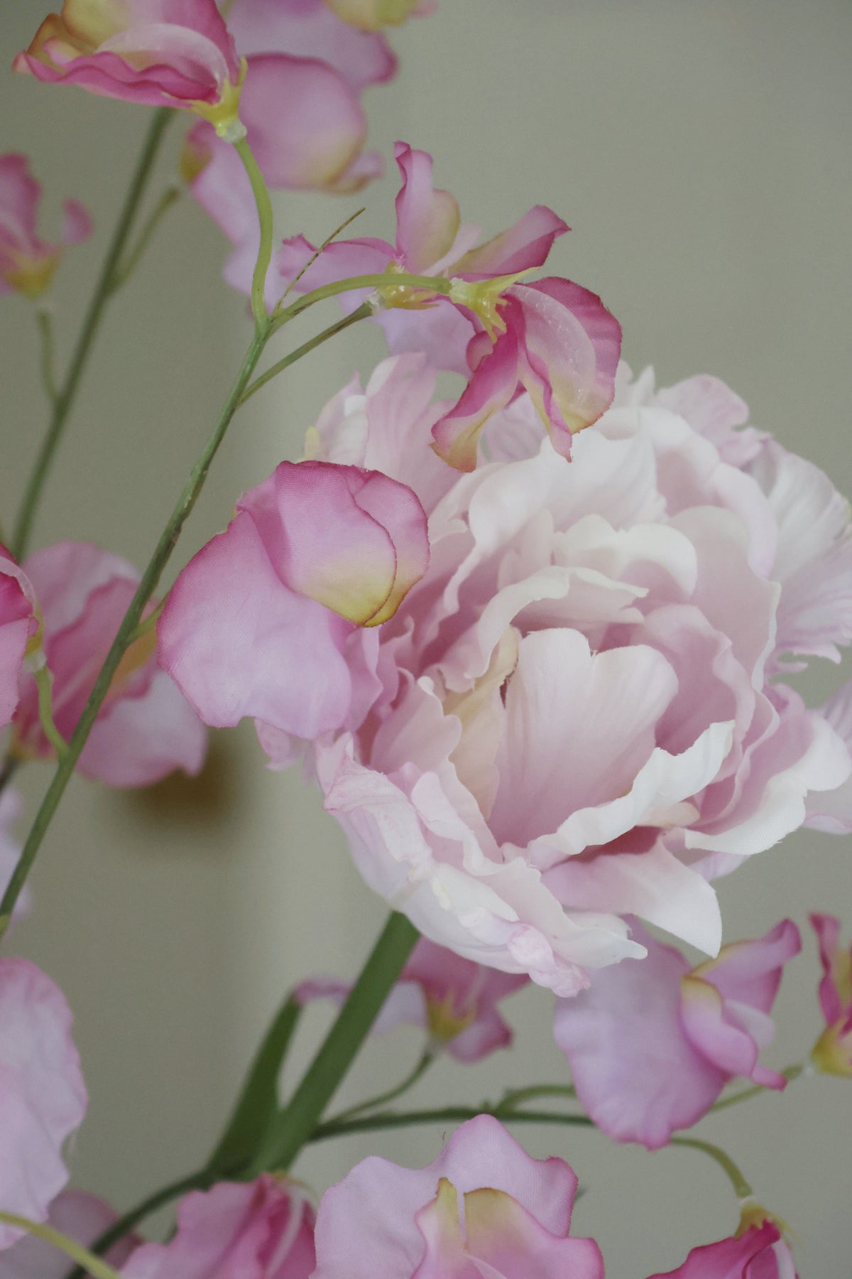 Close-up of pink and lilac faux flowers with a blurred background