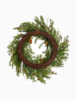 The back of an artificial nordic pinecone wreath for christmas on a white background