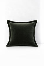 Decorative pillow with velvet trim on a white background