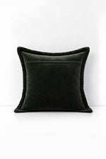 Decorative pillow with velvet trim on a white background