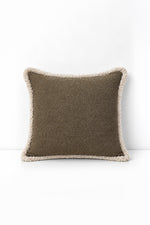 Decorative pillow with weave fringe on a white background