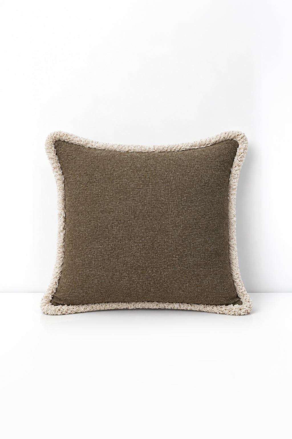 Decorative pillow with weave fringe on a white background
