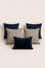 Set of four decorative cushion with blue and beige patterns on a light background