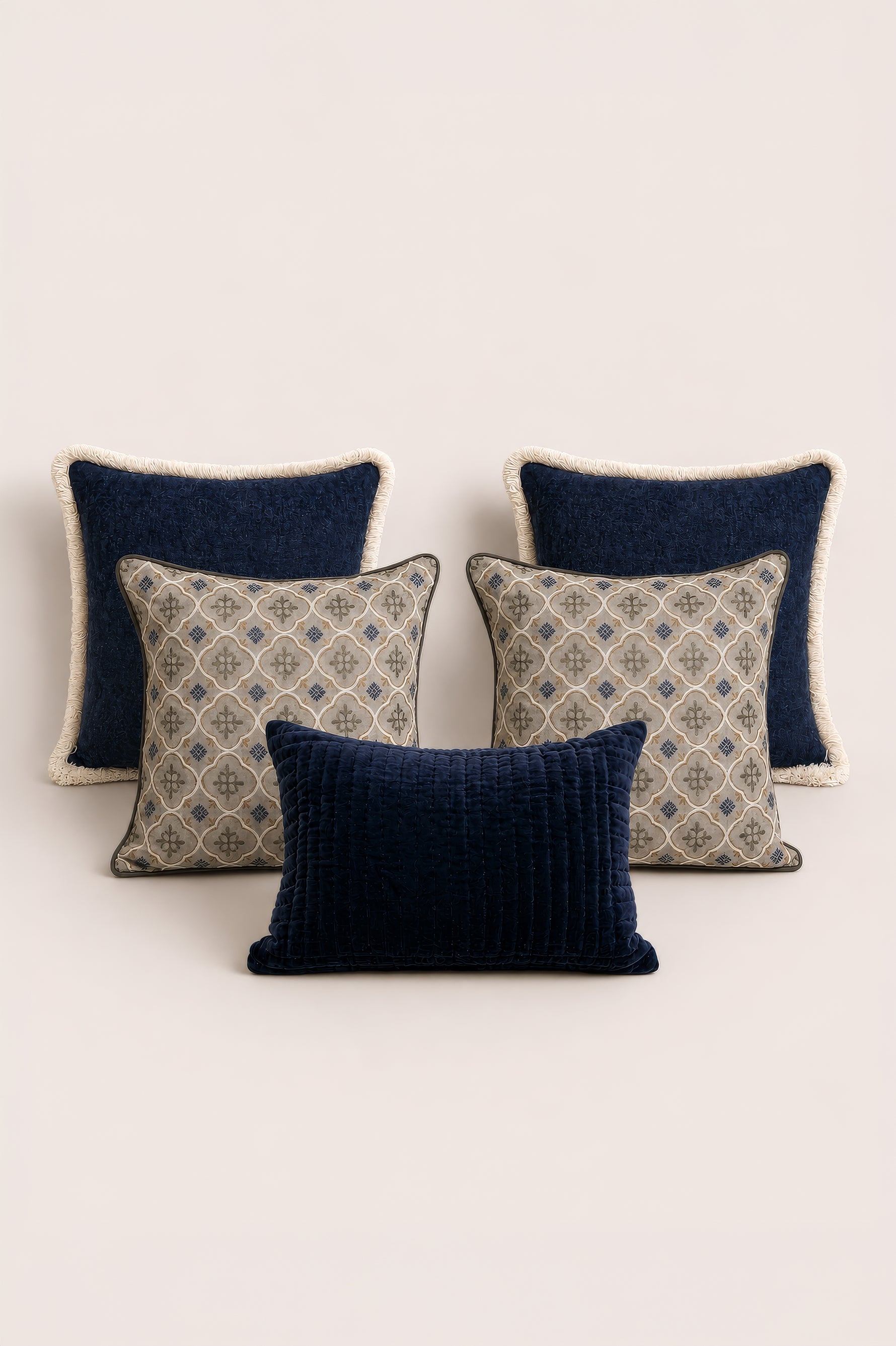 Set of four decorative cushion with blue and beige patterns on a light background