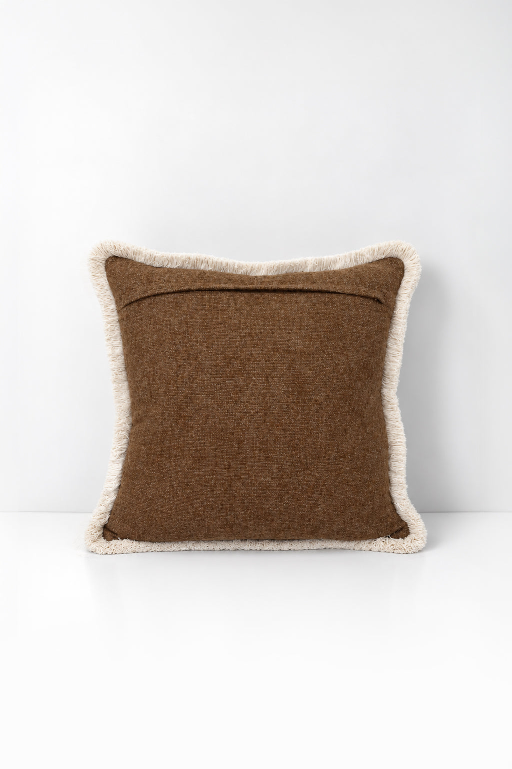 Decorative pillow with weave fringe on a white background