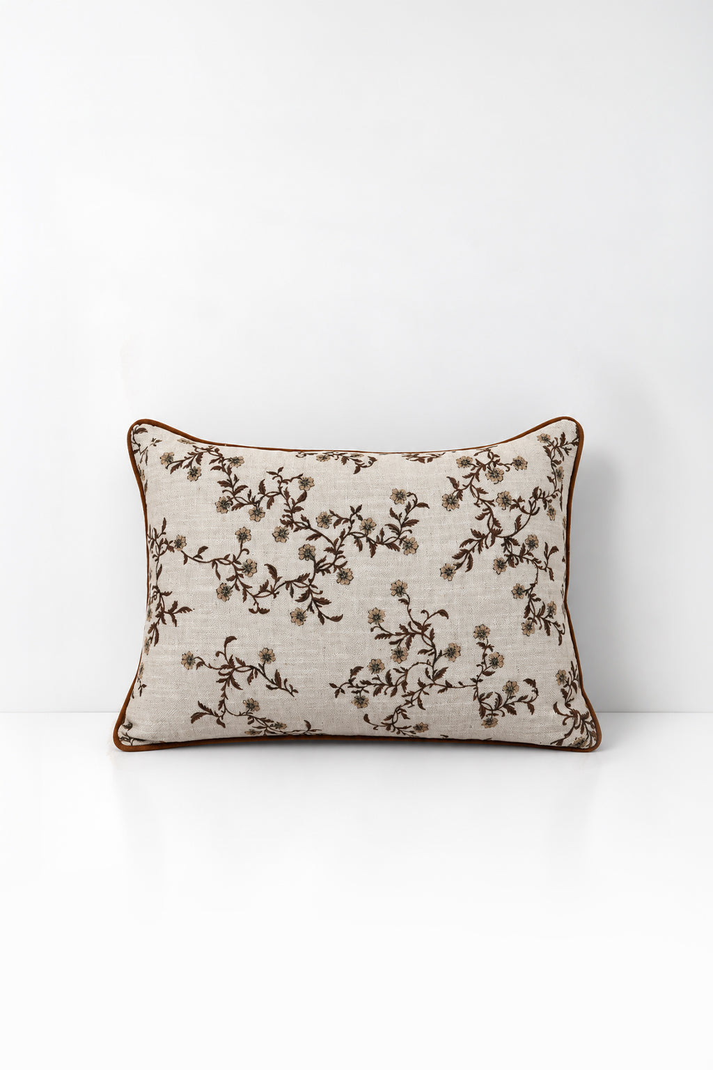 Decorative pillow with wildflower print on a white background