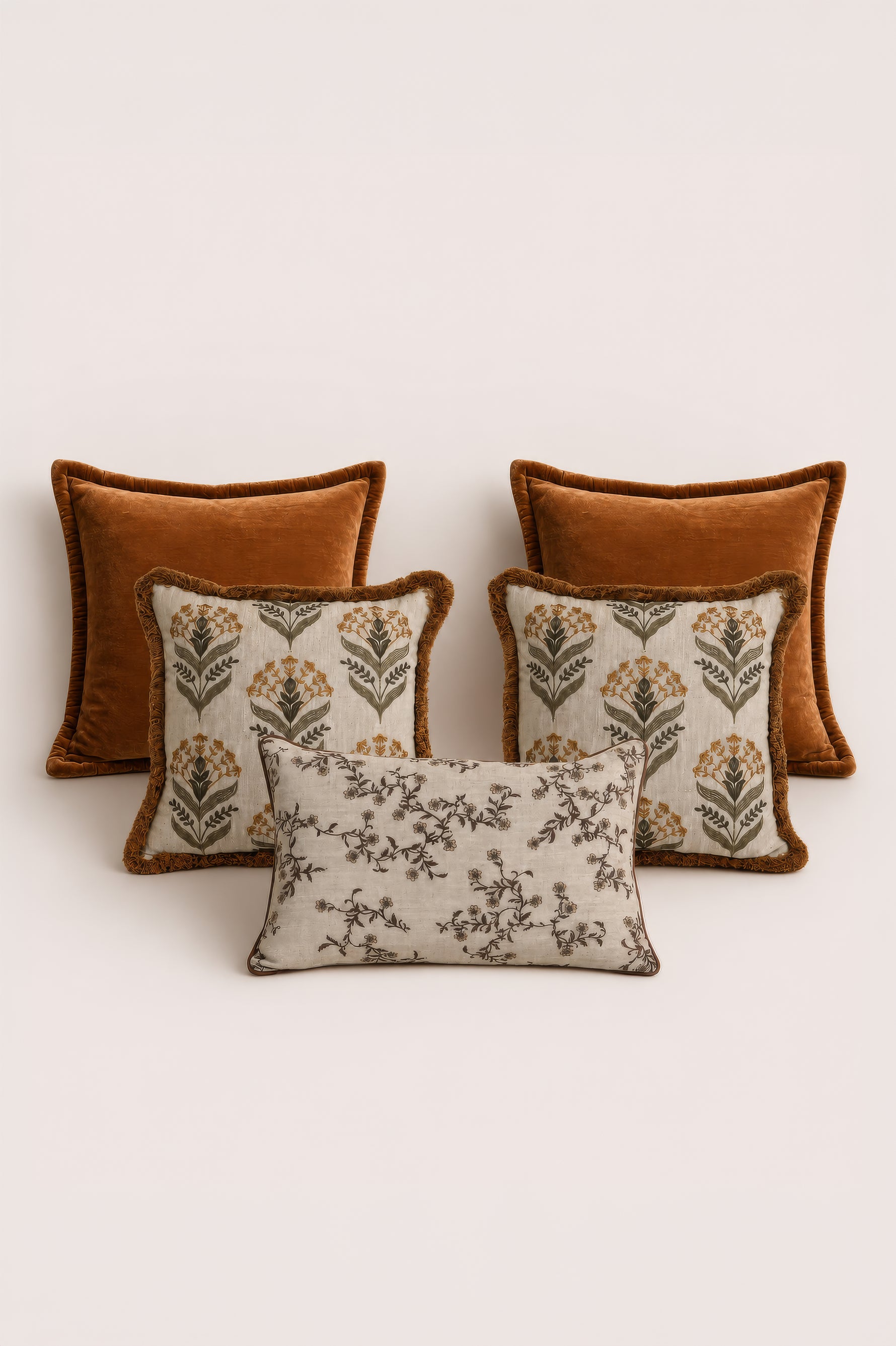 Set of four decorative cushions with floral patterns on a light background