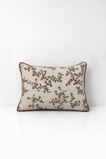 Ochre Wildflower print decorative cushion on a white background