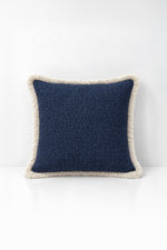 Decorative pillow with weave fringe on a white background