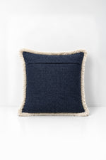 Decorative pillow with weave fringe on a white background