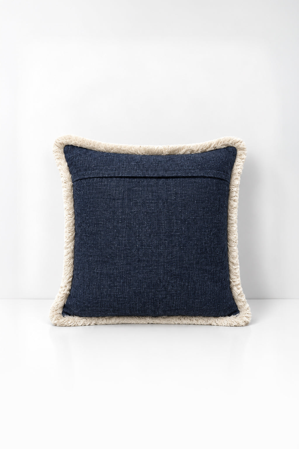 Decorative pillow with weave fringe on a white background
