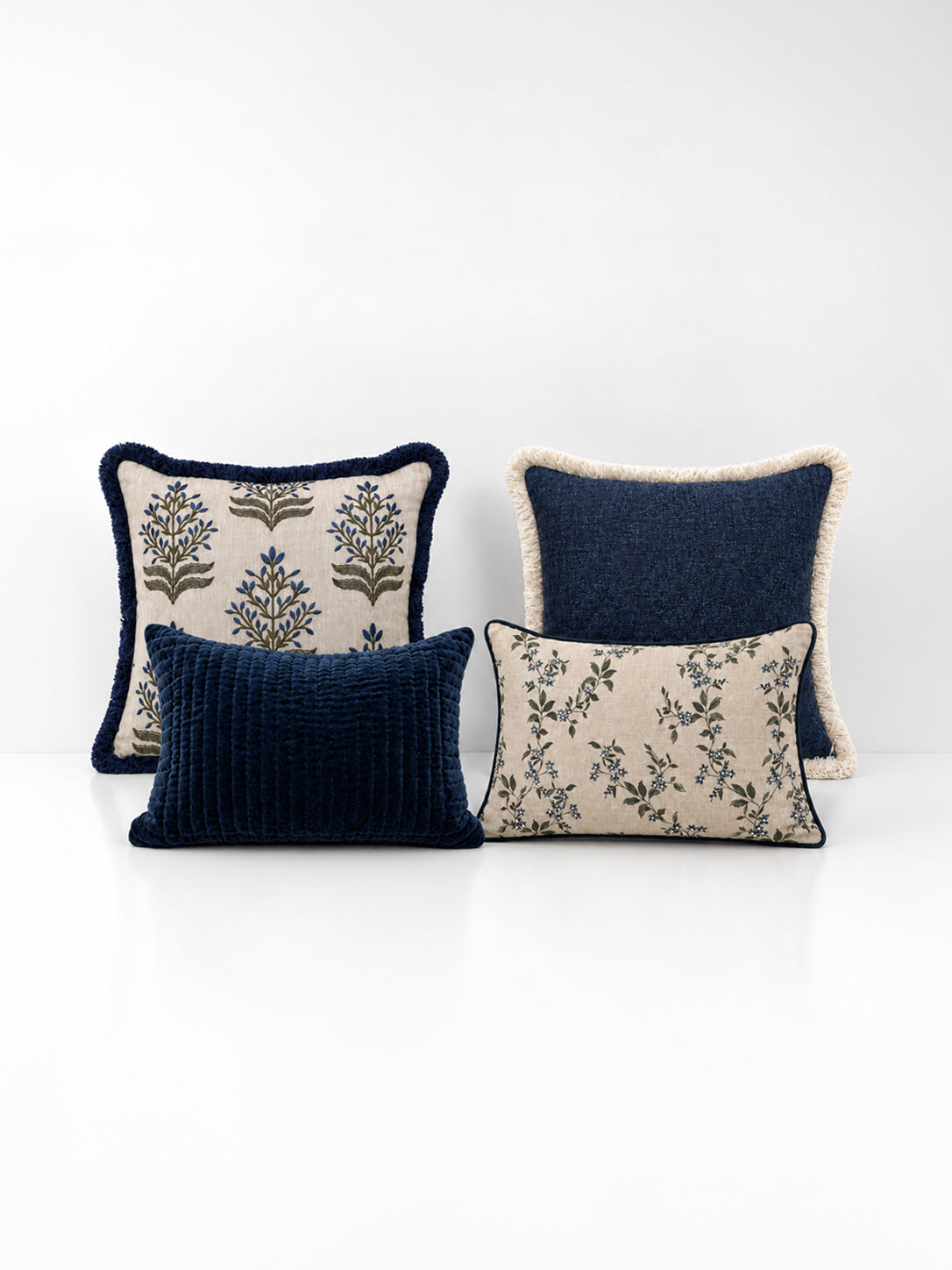 A set of blue decorative cushions on a white background