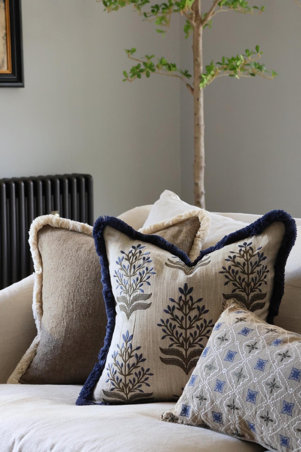 Decorative cushions on a sofa with a neutral background