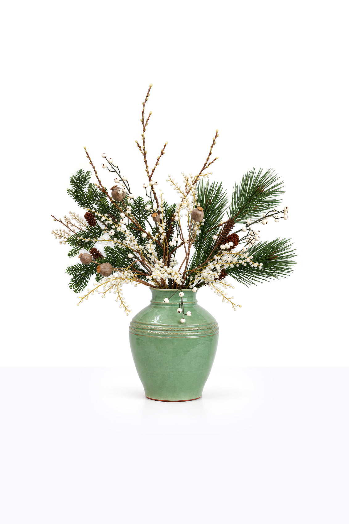 Artificial Christmas White Berry Arrangement in a ceramic urn on white background