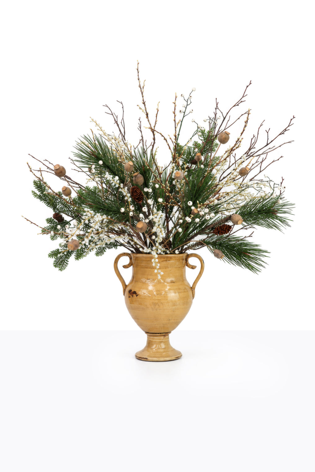 Artificial Christmas White Berry Arrangement in a ceramic urn on white background