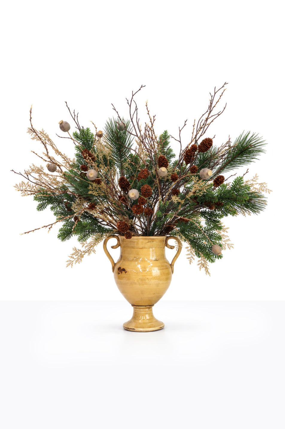 Artificial Christmas Winter Foliage Arrangement in a ceramic urn on white background