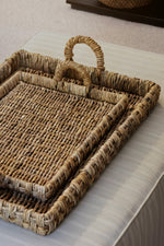 nested rectangular banana bark trays on an ottoman 