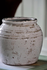 white rustic ceramic pot on blurred background