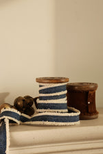 blue decorative ribbon on wooden spool 